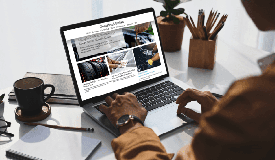 Person browsing a website with native advertising placements integrated into article-style content on a laptop screen.
