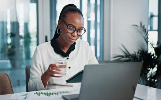 Professional reviewing CRM-based targeting results on a laptop for B2B digital marketing.