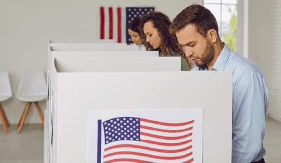 Voters casting ballots in private booths, illustrating targeted political outreach and activation.