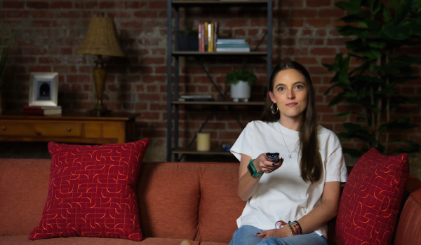 Woman holding a TV remote