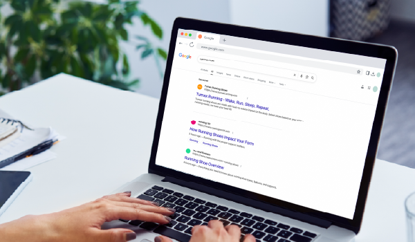 Person using a laptop to view Google search results, representing SEM campaigns